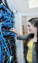 woman it engineer in network server room